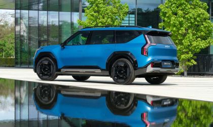 Blue Kia EV9 next to pond
