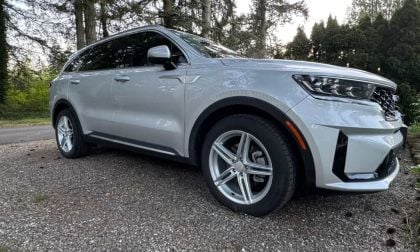 Silver Kia Sorento PHEV parked in a forest