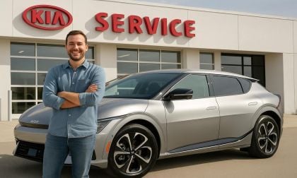 Kia EV6 owner in front of Kia service center