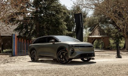Lucid Gravity SUV parked outdoors at event with trees and buildings