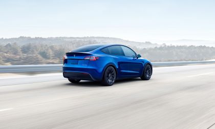 Blue Tesla Model Y Cruising Down The Street