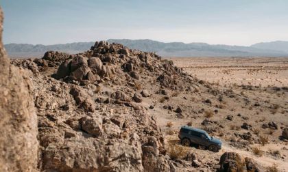 Rivian R1S off road in high desert mountains
