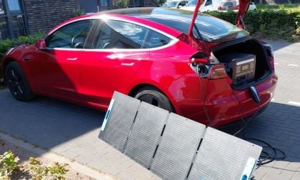 Red Tesla Model 3 with DIY solar power charger