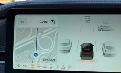 Car navigation screen showing map with 0.2 mile route, vehicle speed of 45 mph, and stylized car icons near In-N-Out Burger location