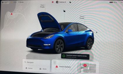 Blue Tesla Model Y with open hood and trunk, displayed on vehicle interface screen with service notification