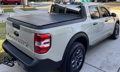 Shawn's 2025 Ford Maverick pickup truck shown from the rear quarter view, featuring a black tonneau cover over the bed and distinctive taillights.