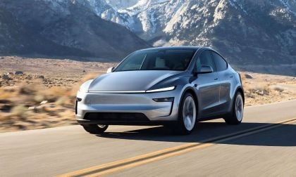 Silver Tesla Model Y on a snowy mountain road