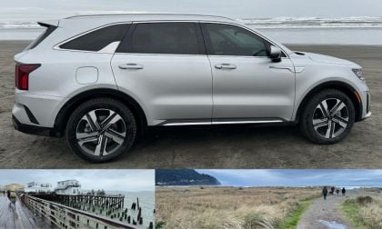 Silver Kia Sorento PHEV on the beach and people by the water on Oregon shore