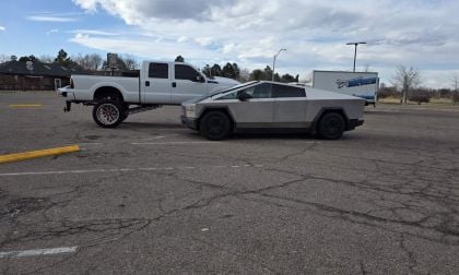 Tesla Cybertruck next to White Ford 