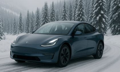 Tesla Model 3 driving on a cold, snow-covered mountain road