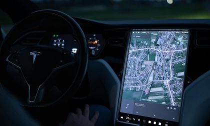 Tesla Model S interior with screen showing the map of a city in extreme detail