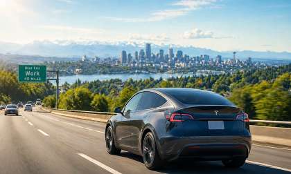 Tesla Model Y driving to a city on an interstate, long commute.