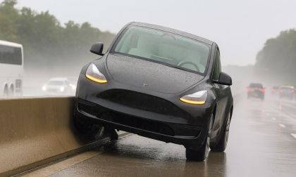 Picture of a Tesla Model Y on a highway concrete center divider