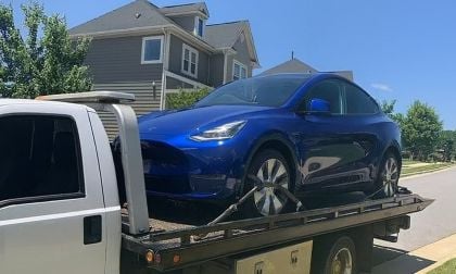 Tesla Model Y on the back of a flatbed towing truck