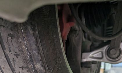 Picture of rear tire on a Tesla with excessive wear on the inside due to poor camber adjustment