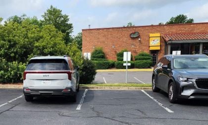 The 2025 Kia Carnival Hybrid SX Prestige parked at a parking lot next to a Mazda