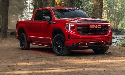 A 2026 Red GMC Sierra with custom headlights.