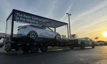 A Tesla Pulling a Tesla: Advertising In Glass Display On Truck Bed: Mobile Advertising of Tesla At Its Finest