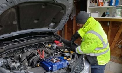 Image of AAA technician changing battery by John Goreham