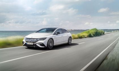 Image showing a white Mercedes AMG EQE driving on a coast road.
