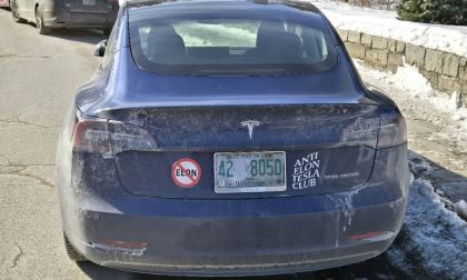 Image showing anti-Elon Musk bumper stickers on a Tesla Model Y