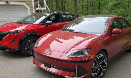 A Hyundai Ioniq 6 and Nissan Ariya sit side by side in brilliant red