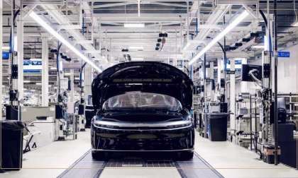Image showing a black Lucid Air with its hood open on the production line at AMP-1