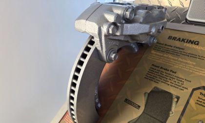 An automotive brake display explains how the rotor, caliper and brake pads work