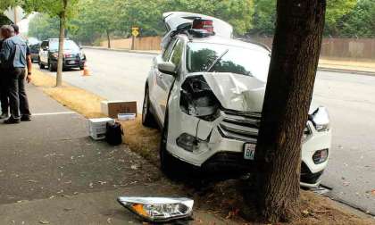 Officers (in rear) Investigate After A Car Hits A Tree