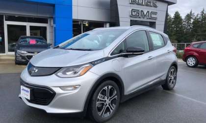 Chevy Bolt in front of Chevrolet Dealership 1200x900