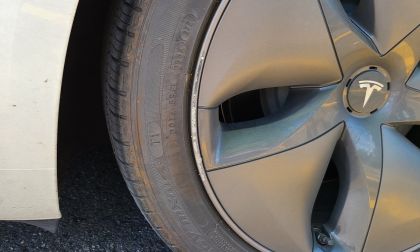 Tesla Model Y rim with scuffed paint from hitting a curb