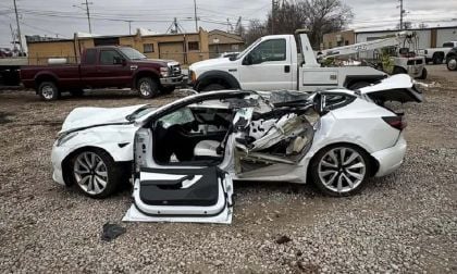 Severely damaged Tesla Model 3 in a junk yard after cash