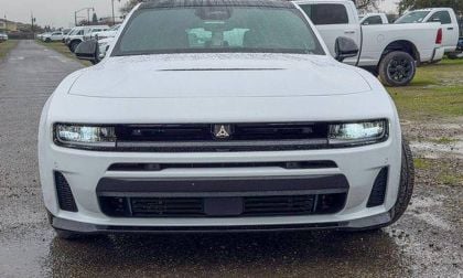 White Dodge Challenger muscle car front view in parking lot