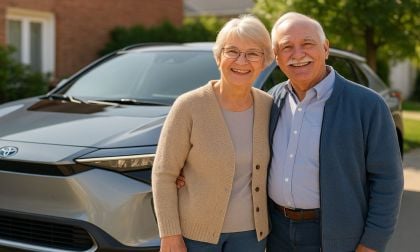 Senior couple in front of their Toyota bZ4X electric vehicle