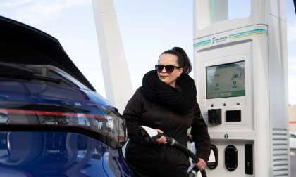 Image of EV owner charging in cold wearer courtesy of Electrify America