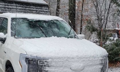 A Ford F-150 sits frozen in ice with its wipers in the up position