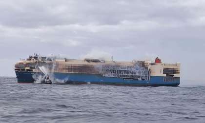 Image showing a firefighter boat attempting to put out the fires aboard the fire-ravaged Felicity Ace car carrier ship.