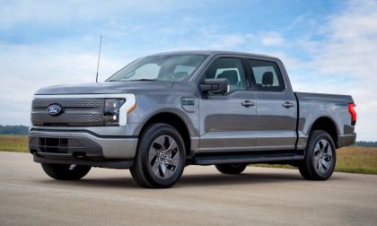 Gray Ford F-150 Lightning Flash electric pickup truck front three-quarter view parked on pavement