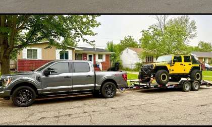 Ford F-150 pickup shown towing a yellow Jeep Wrangler on a flatbed trailer