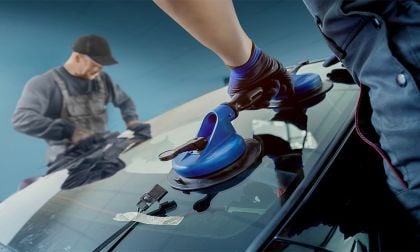 Technicians install new windshield in a Ford Product