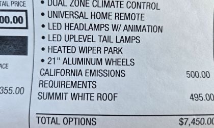 Window sticker from a Chevrolet Equinox EV with a $500 fee is shown