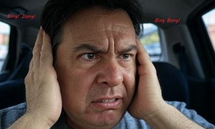 Image shows a man covering his ears while car warning chimes drive him crazy created using Grok by John Goreham