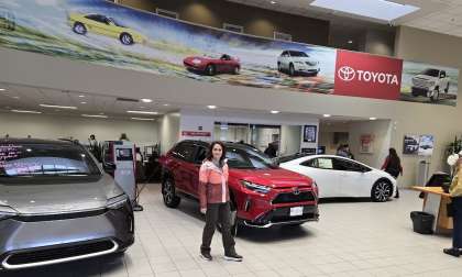 A shopper looks for good deals in a Toyota showroom