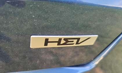 A hybrid logo from Kia is shown