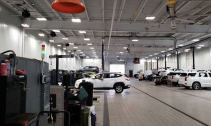 Image shows a Hyundai dealer service area performing repairs on various models