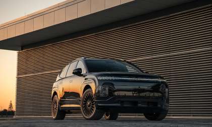 Black Hyundai Ioniq 9 electric SUV shown from the front three-quarter angle at sunset.