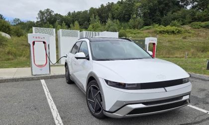 A 2026 Hyundai Ioniq 5 Limited charges at a Tesla Supercharger occupying two spaces