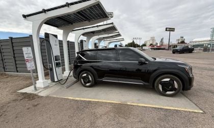 Black Kia EV6 electric vehicle charging at solar-powered charging station