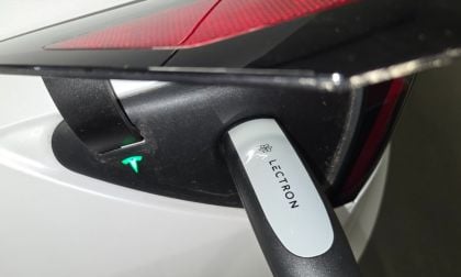 A Tesla Model Y is charged using a portable Lectron Level 2 charger during testing