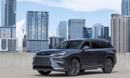 Gray Lexus TX SUV parked with city skyline behind